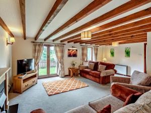 a living room with a couch and a tv at 4 Bed in Holsworthy oc-lamer in Merryfield