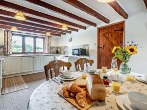 a dining room with a table with bread on it at 4 Bed in Holsworthy oc-lamer in Merryfield