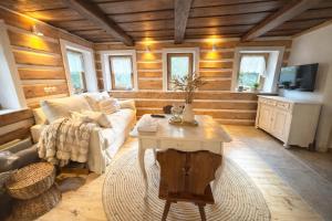 a living room with a couch and a table at Kouzelná chalupa u lesa in Krompach