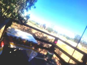 a wooden bench sitting next to a fence at Refugio del Pirata Algarrobo in San Antonio
