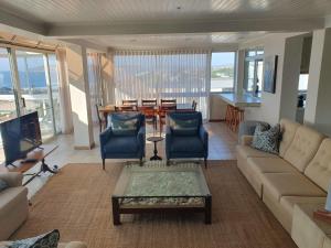 a living room with a couch and chairs and a table at Nice Sea View in Plettenberg Bay