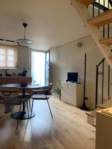 a kitchen and living room with a table and chairs at Sol 41 in Bragança