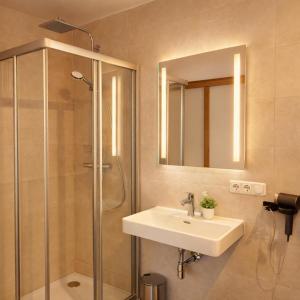 a bathroom with a sink and a shower at Bio Hof Bichler in Mariazell