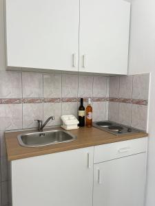 a kitchen counter with a sink and a bottle of wine at Villa Mare in Makarska +53 photos