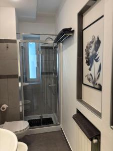 a bathroom with a shower and a toilet at Suite Casina al Lago in Lavena Ponte Tresa