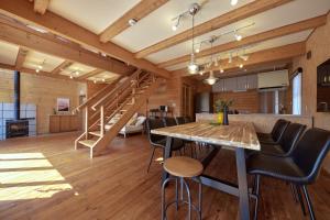 an open kitchen and dining room with a table and chairs at IZA moriyama in Moriyama