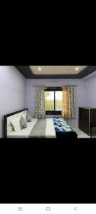 a bedroom with a large bed and a window at Hotel Jaanvi in Orchha