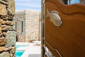 a fish head on the door of a house at Greco Philia Hotel Boutique by Mr and Mrs White in Elia Beach