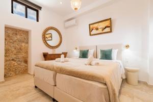 a bedroom with a large bed and a mirror at Kristina´s rooms in Rhodes Town