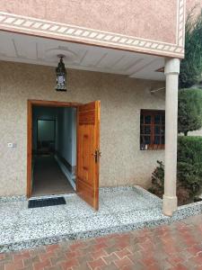 an open door to a building with a porch at villa ourika complette in Sbiti