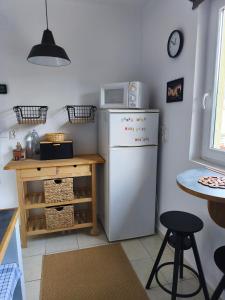 a kitchen with a white refrigerator and a table at Somló Home in Somlószőlős +16 photos