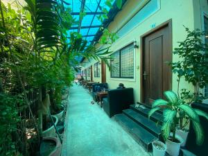 a hallway with benches and plants in a building at Pov Monique 2 in Stœ̆ng Trêng