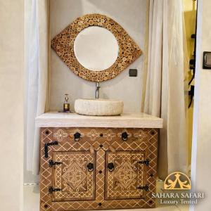 a bathroom with a sink and a mirror at Sahara Safari Luxury Camp & Activities in Merzouga +36 photos