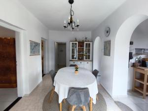 a dining room with a white table and chairs at Somló Home in Somlószőlős
