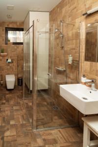 a bathroom with a shower and a sink at Žvėrinčiaus vila in Birštonas +18 photos