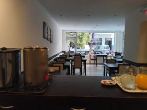 a dining room with tables and chairs and oranges on a table at Lido in Mar del Plata