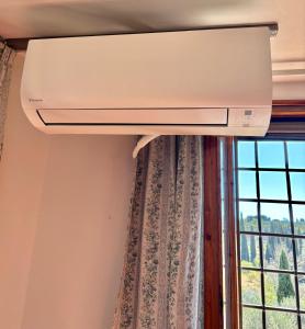 a ceiling fan in a room with a window at Villetta Gabriella in Impruneta +12 photos