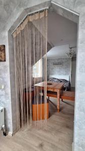 a room with a bed and a table with curtains at Guest House Krista in Jūrmala