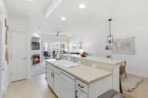 a white kitchen with a sink and a counter at 2B 2B Lake View Pool Hot Tub in Lake Ozark