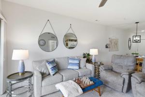 a living room with a couch and chairs and mirrors at 2B 2B Lake View Pool Hot Tub in Lake Ozark