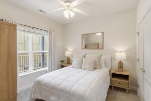 a white bedroom with a bed and a window at 2B 2B Lake View Pool Hot Tub in Lake Ozark