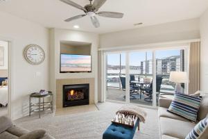a living room with a fireplace and a tv at 2B 2B Lake View Pool Hot Tub in Lake Ozark