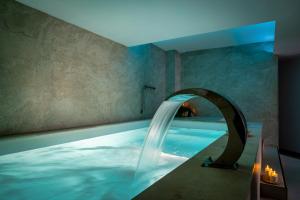a swimming pool with an archway in a room at FERGUS Style Palma Beach - Adults Only in Can Pastilla