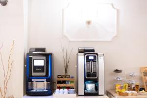 an old pepsi machine sitting next to a larger one at Hotel RomAntica in Rome