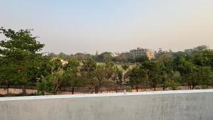 a view of a park with trees and buildings at Subhash Guest House in Gaya +2 photos