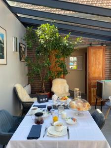 a table with plates of food on it at La Maison Angèle in Caisnes +21 photos