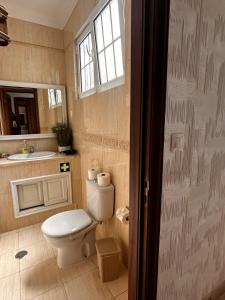 a bathroom with a toilet and a sink at Azor International House in Ponta Delgada