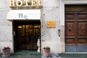 a building with a dog sitting outside of a hotel at Hotel RomAntica in Rome