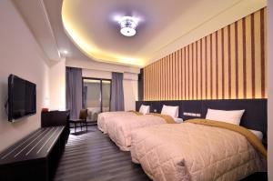 Ένα ή περισσότερα κρεβάτια σε δωμάτιο στο Yundu Business Hotel