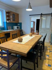 a dining room with a wooden table and chairs at Cosynumber8 in Bar-sur-Seine