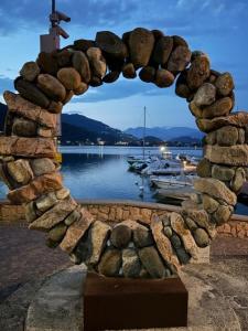 a stone archway with a view of a body of water at Suite Casina al Lago in Lavena Ponte Tresa
