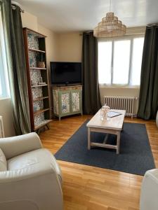 a living room with a couch and a coffee table at Cosynumber8 in Bar-sur-Seine
