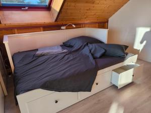 a bed in a tiny house with a window at Ferienwohnung am Soonwald in Ellern +27 photos