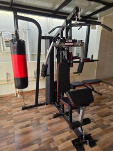 a gym with a punching bag and a squat rack at Om Sai Ram Coliving in Bangalore