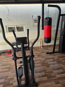 a room with a gym with a treadmill and a punching bag at Om Sai Ram Coliving in Bangalore +6 photos