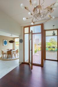 a dining room with a dining table and a chandelier at Villa Sirena Apartments in Pärnu
