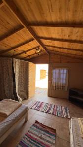a room with a bed and a rug on the floor at Anne in Nuweiba