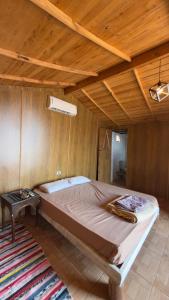 a large bed in a room with a wooden ceiling at Anne in Nuweiba +2 photos