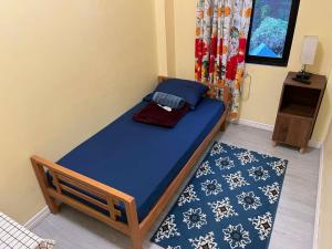 a bedroom with a blue bed and a blue rug at Tipid Camp Baguio A4,A5,A6 in Baguio