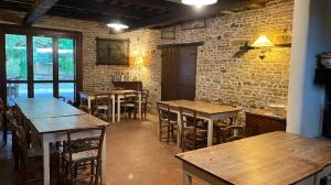 a restaurant with tables and chairs and a brick wall at Agriturismo Case Mori in Rimini