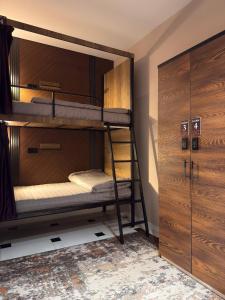 a bunk bed room with two bunk beds and a locker at TWENTY Hostel in Samarkand