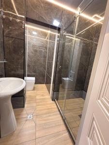 a bathroom with a shower and a sink at TWENTY Hostel in Samarkand +8 photos