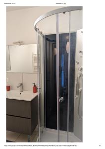 a shower in a bathroom with a sink at Centre Granville in Granville