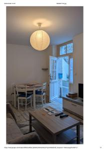 a living room with a table and a dining room at Centre Granville in Granville