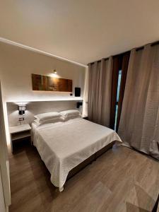 una camera da letto con un letto bianco e una finestra di Confidence Hotel Parma a Parma Altre 12 foto