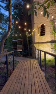 a wooden walkway with lights on a building at Hospedagem de Charme Te Amo in Canela +14 photos